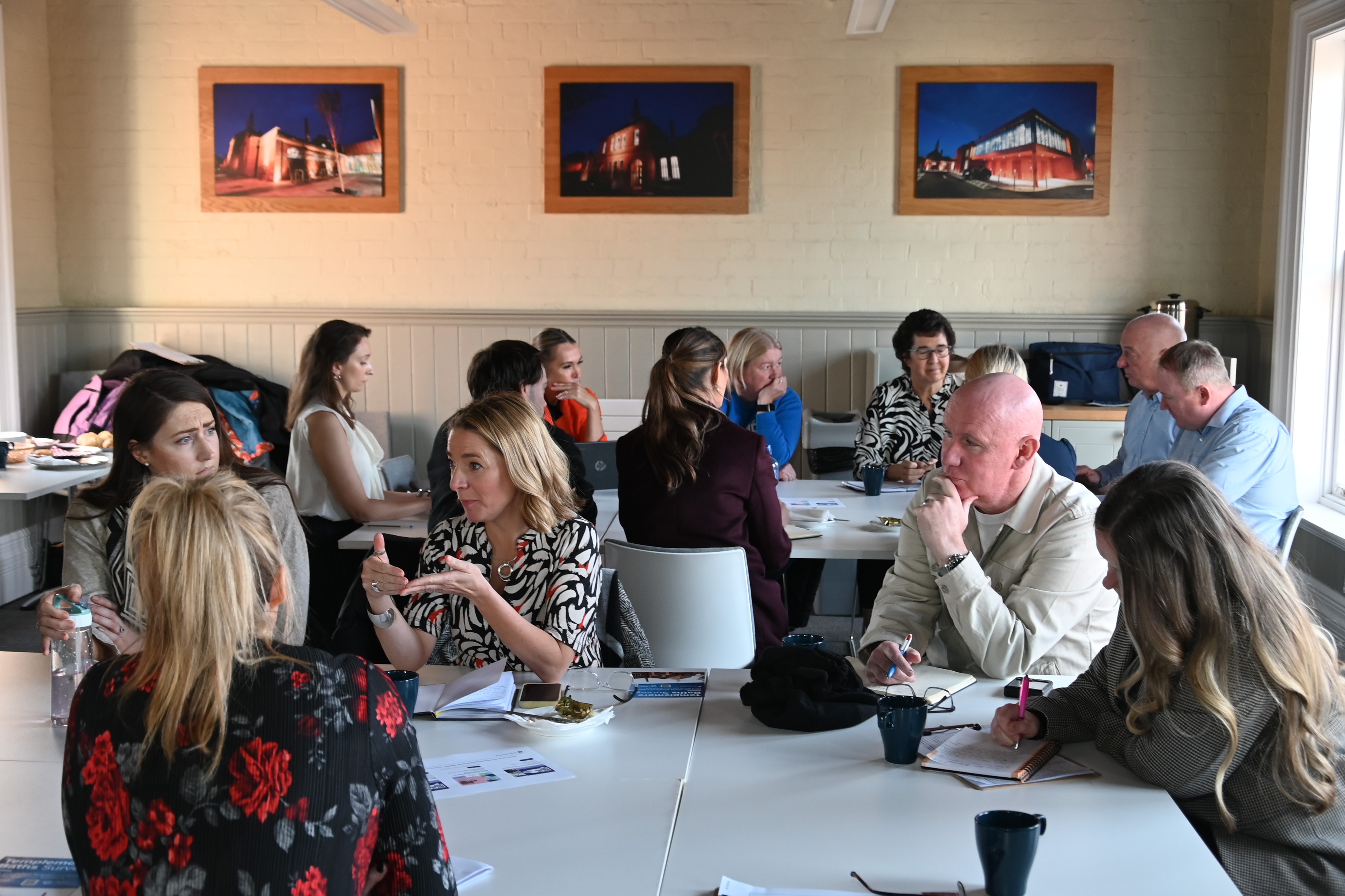two groups of people around round tables participating in an SENI workshop