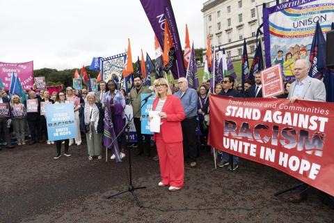 Photo of Celine McStravick speaking at the Anti Racism Rally at the steps of Stormont