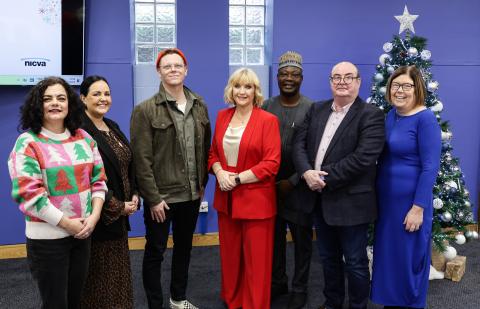 Photo of Darren McGarvey standing with NICVA CEO Celine McStravick and some of the NICVA Executive Committee