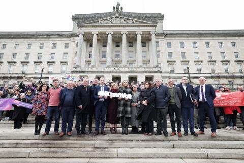 Voluntary and community sector staff, volunteer and services users unite on the steps of Stormont with political representatives.
