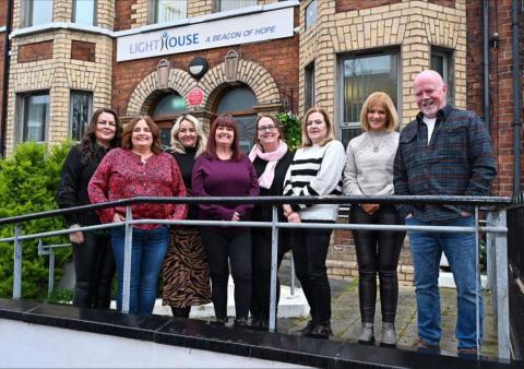 Lighthouse Staff outside the building celebrating the end of their 20th Anniversary 2023